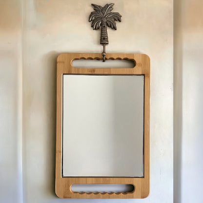 The eco-friendly bamboo mirror sitting nicely on our palm tree brass hook in antique, 