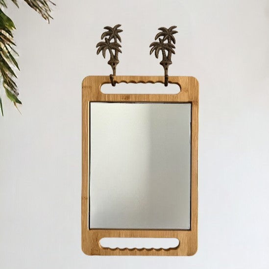 Stylish wall decor using the brass duo palm hooks in antique and our eco-friendly bamboo mirror in caramel.