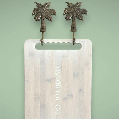 Two palm tree hooks in the antique finish creates a simple space for your bamboo mirrors.