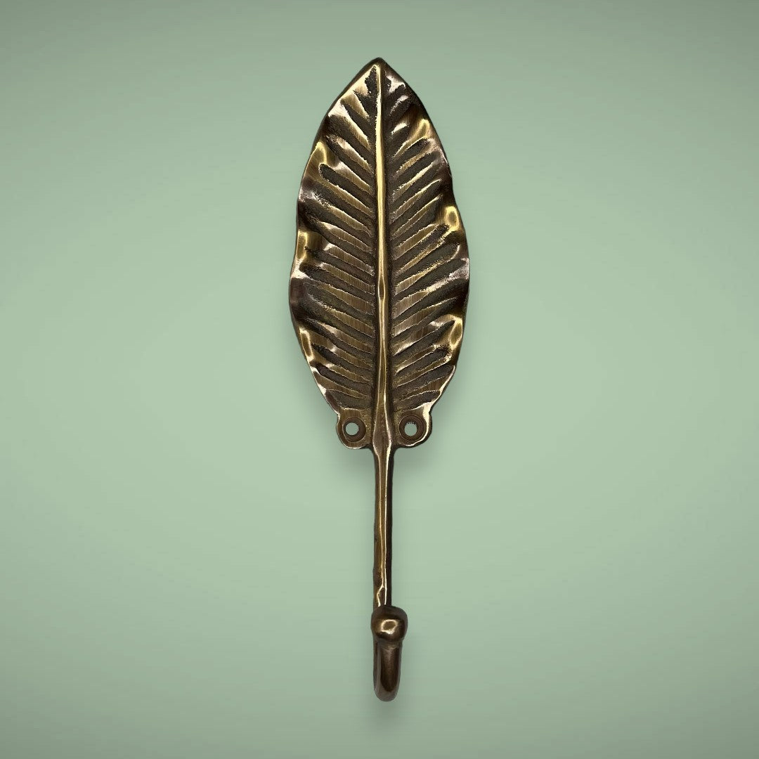 Create tropical vibes in your space with the antique brass banana leaf hook.