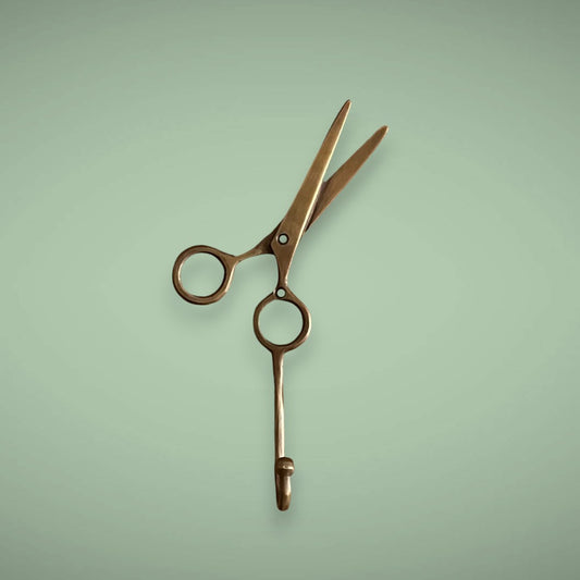 Hang your capes, aprons, keys or our eco-friendly bamboo mirror on our custom brass scissor in antique.