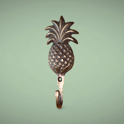 The pineapple brass hook in an antique finish.