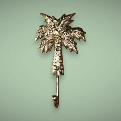 Add this brass palm tree hook in gold to your wall.