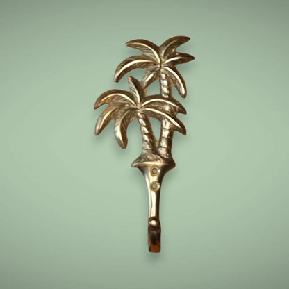 Hang anything on this golden duo palm brass hook for your wall.