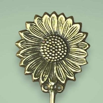 Glow like the sunflower brass hook in gold.